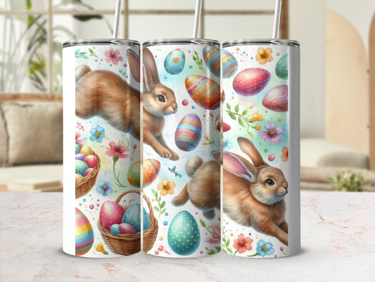 Easter bunnies and colorful eggs on a white tumbler with floral accents.