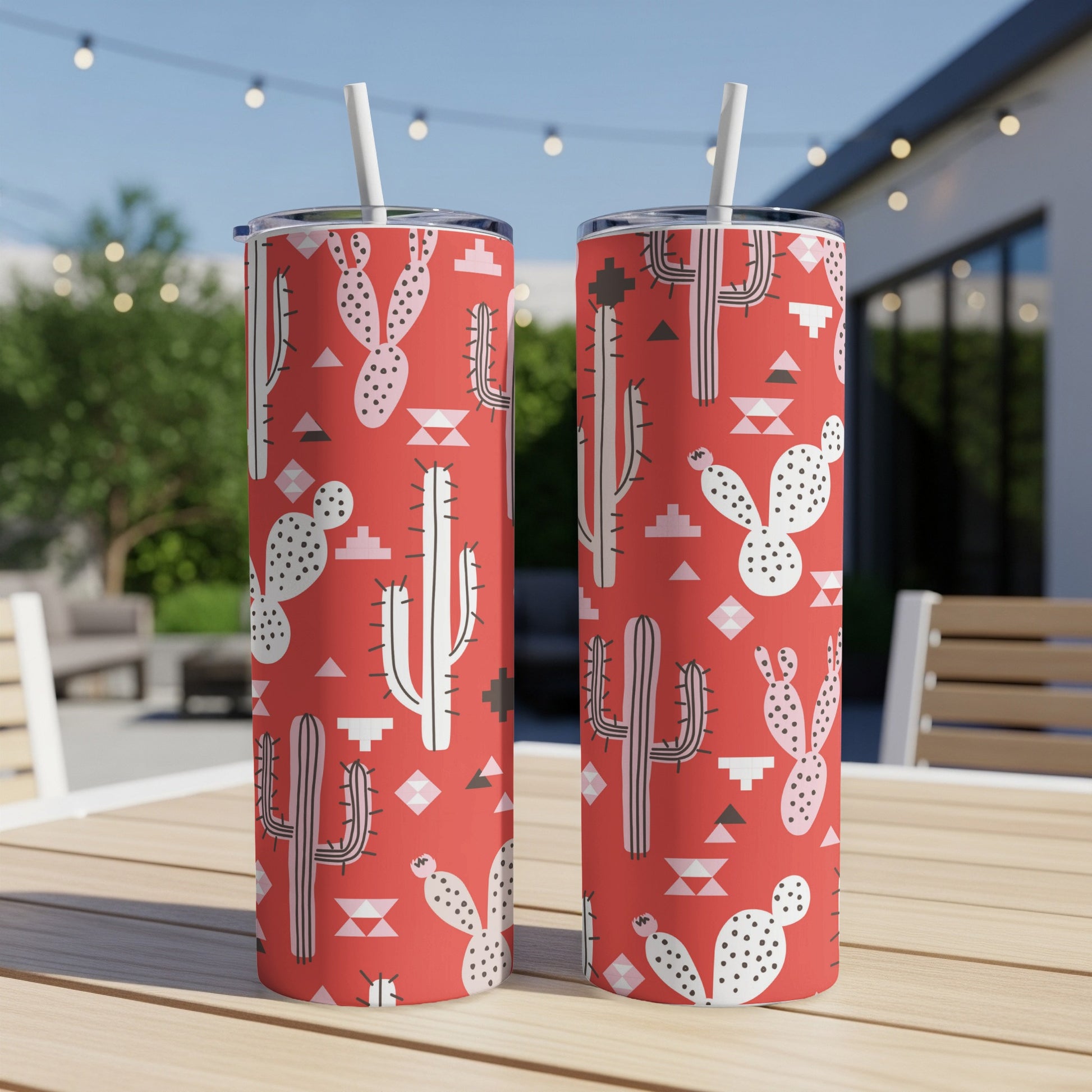 Two tall tumblers with a red background and a repeating cactus and geometric pattern.