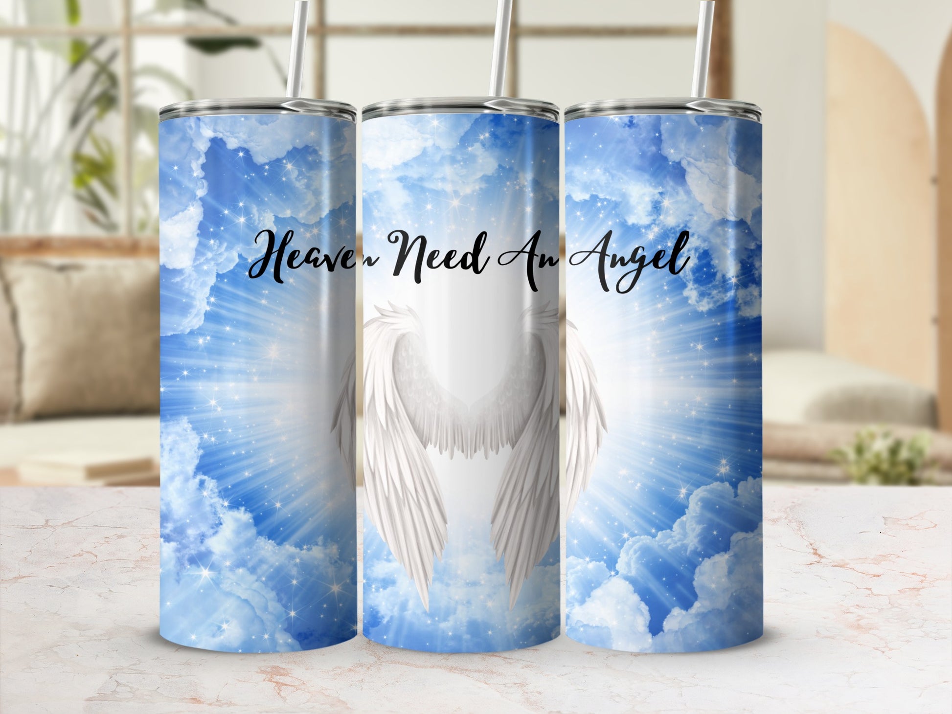 Heavenly wings and clouds design on a white tumbler.