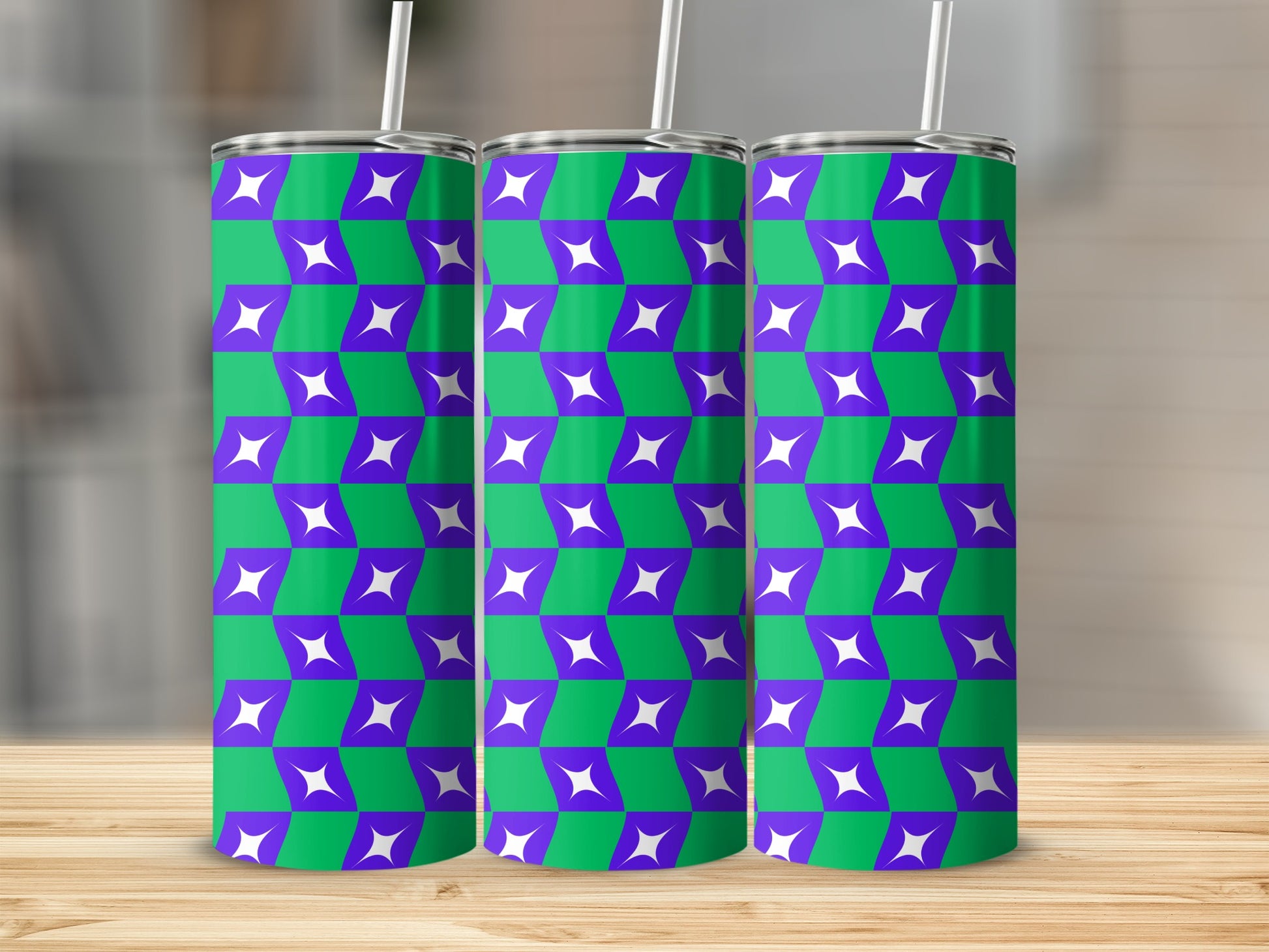 Three tumblers with purple and green geometric star pattern and white straws.