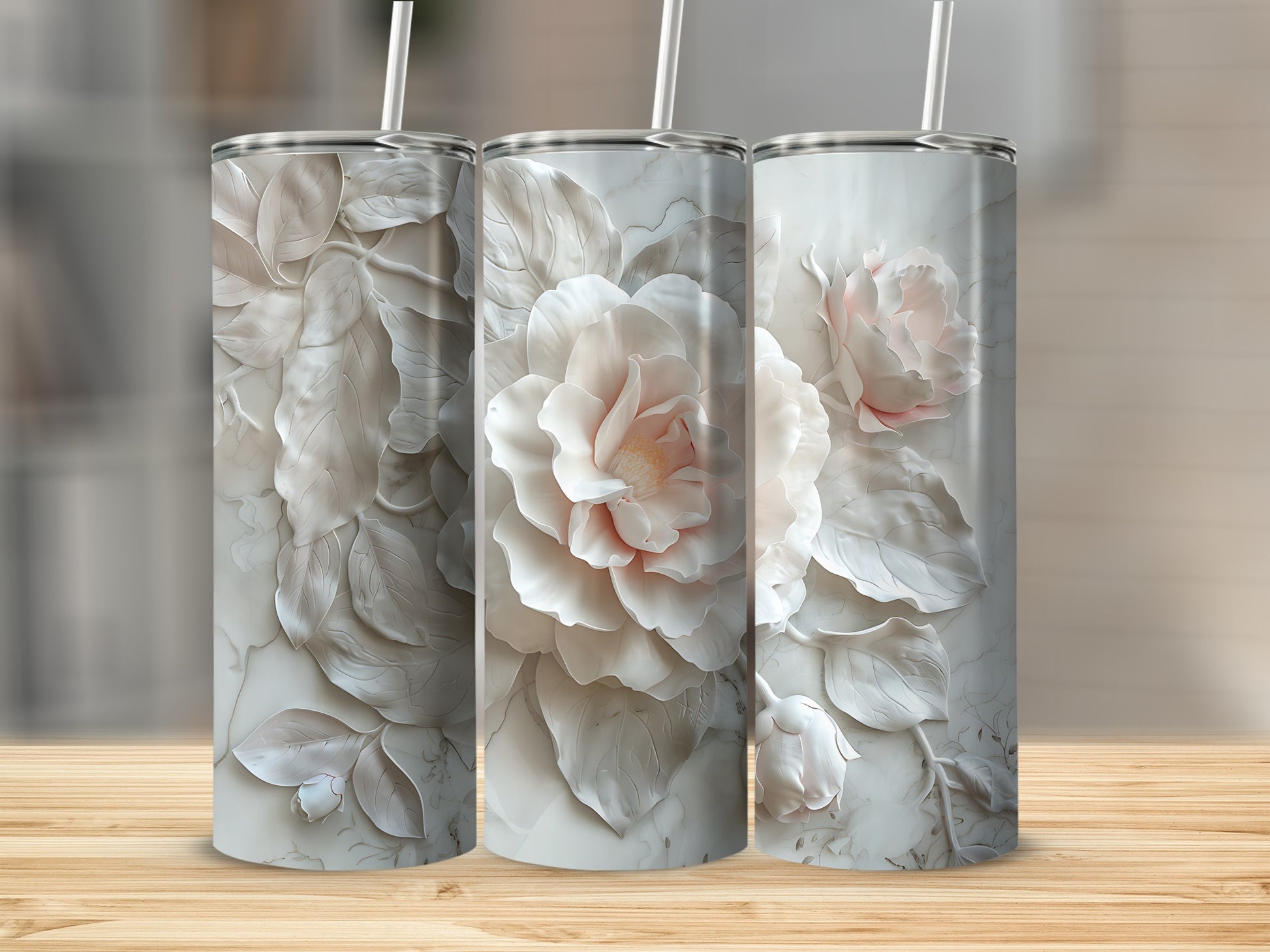 Three tumblers with embossed light pink and cream floral designs.