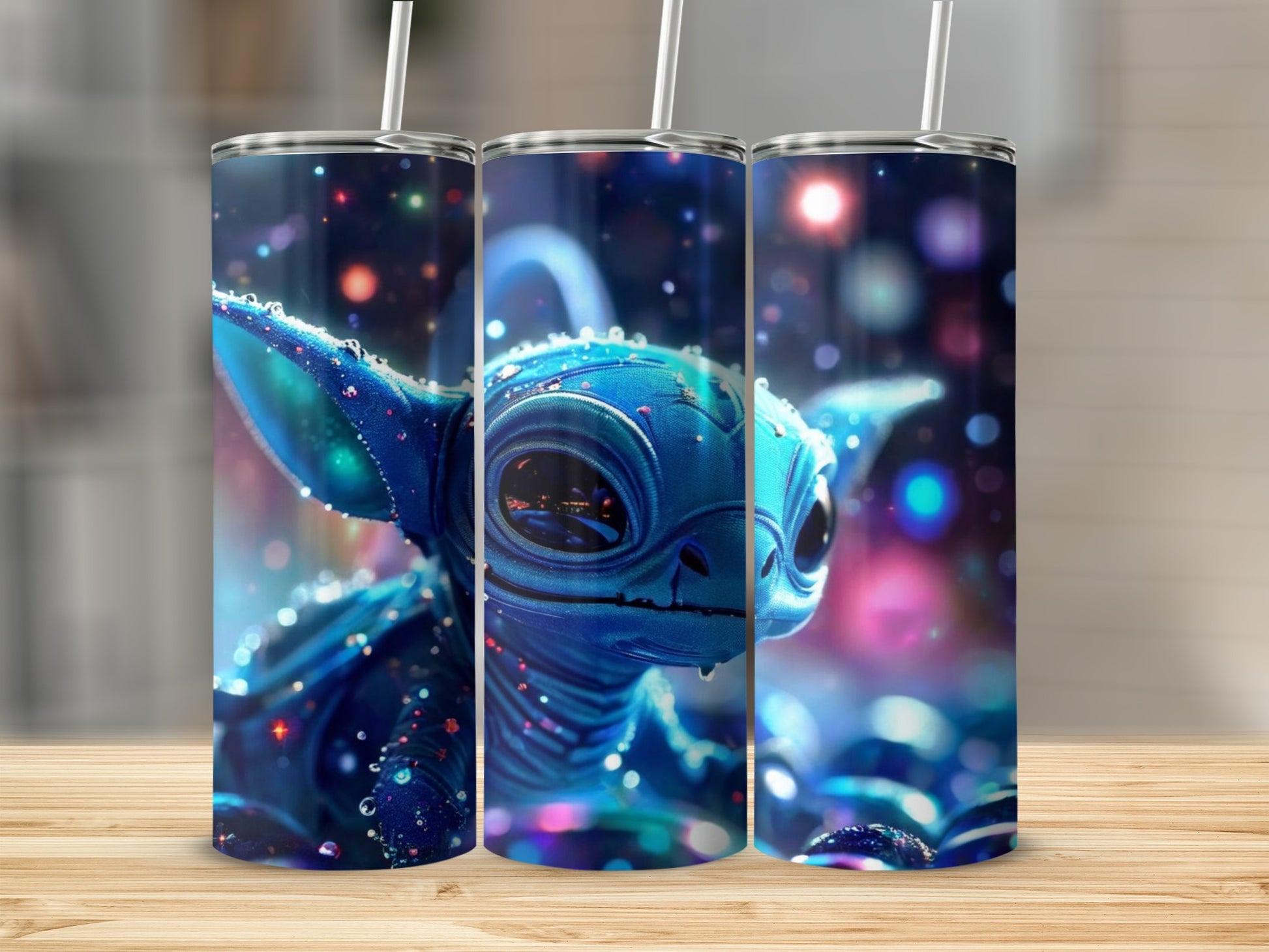 Three blue alien tumblers with sparkly, cosmic background.