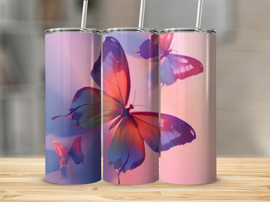 Three tumblers with colorful butterfly designs against a soft gradient background.