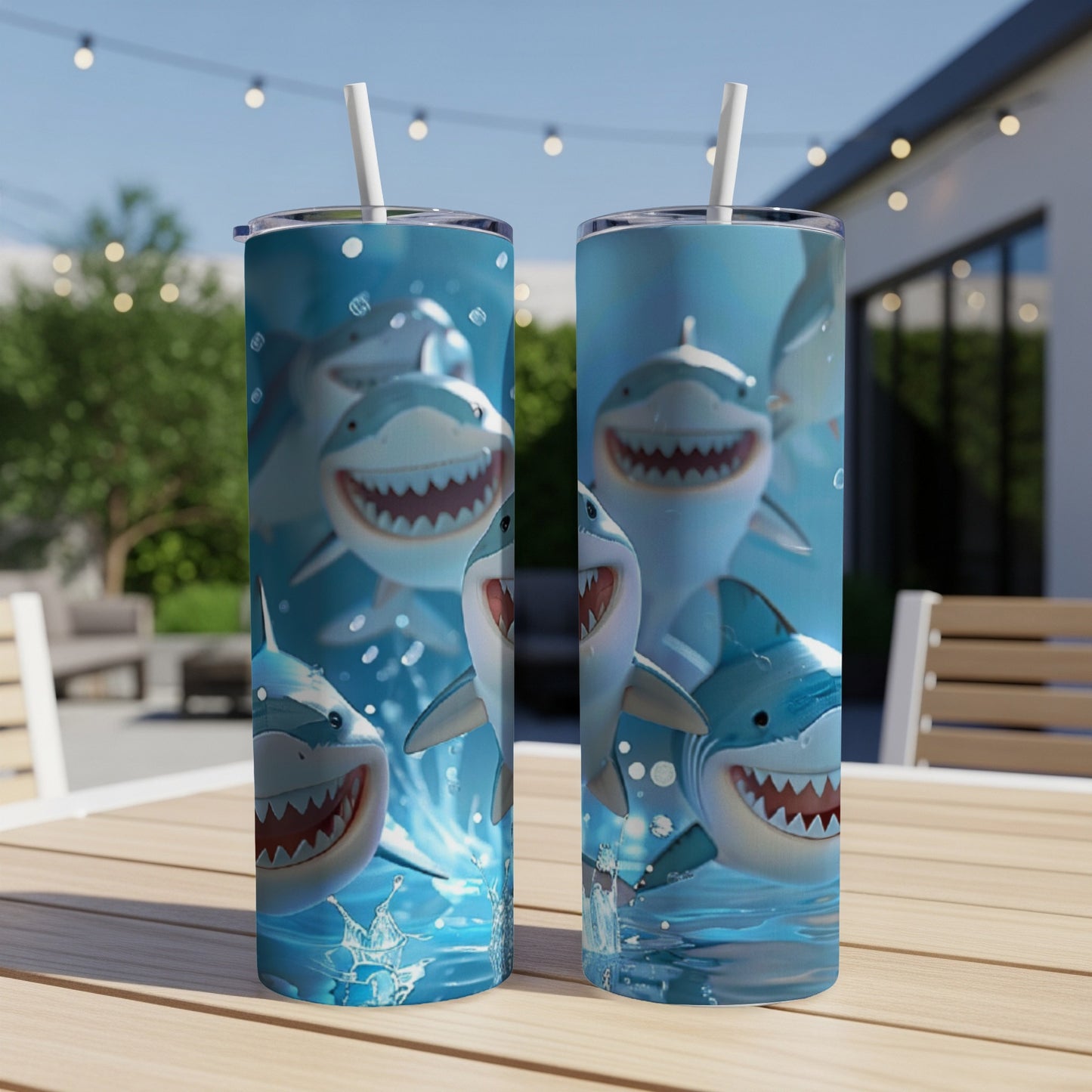 Two tumblers with smiling cartoon sharks and water splashes.