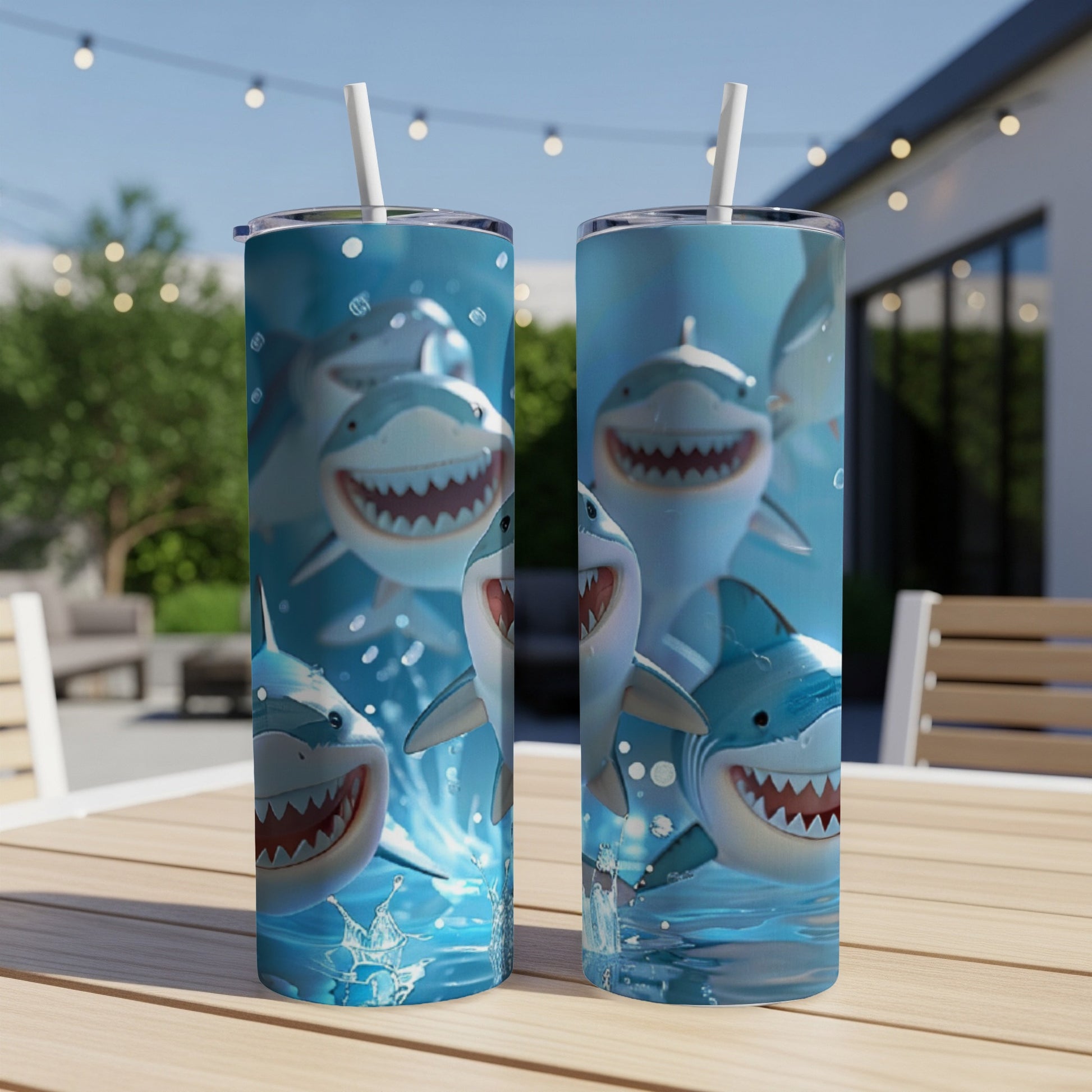 Two tumblers with smiling cartoon sharks and water splashes.