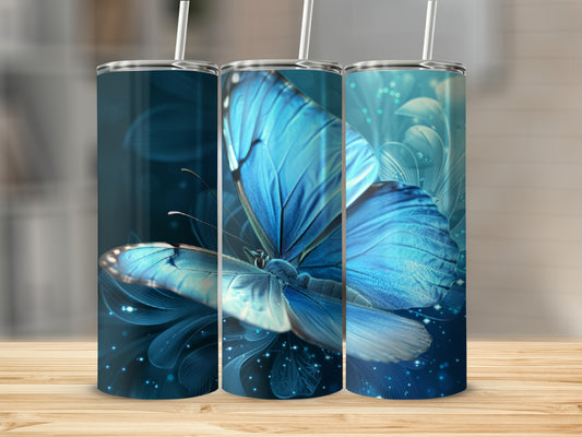 Three blue butterfly tumblers with straw on a wooden surface.