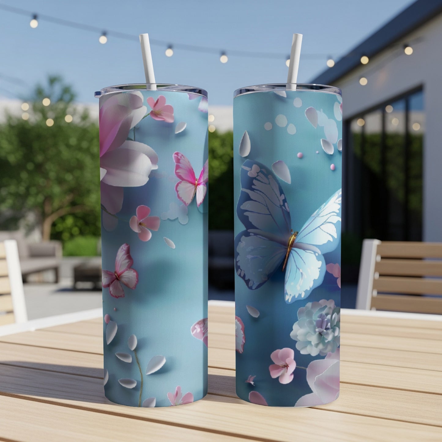 Two tall, slender tumblers with a blue floral and butterfly design.
