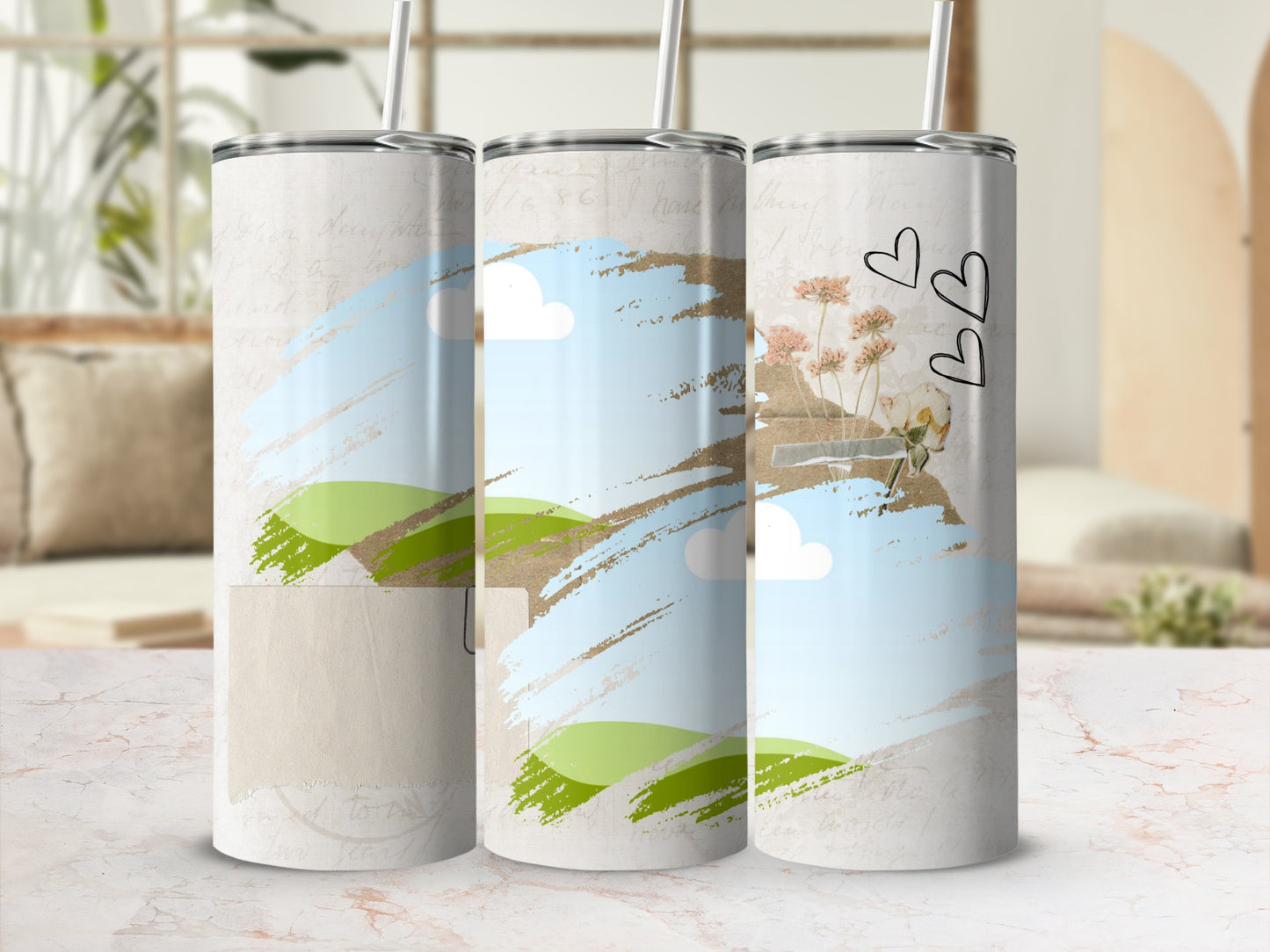 Three tumblers with a watercolor landscape and floral design with hearts.