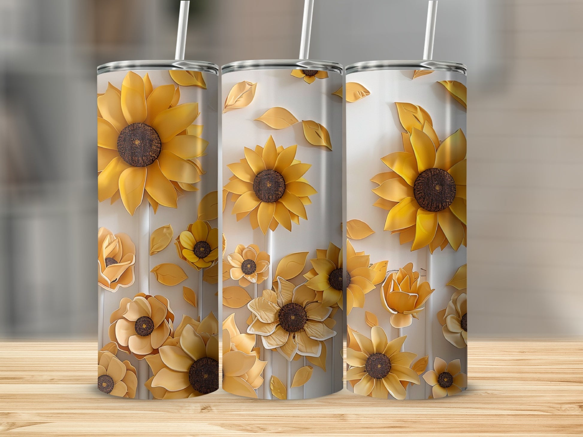 Three tall tumblers with a pattern of sunflowers and leaves.