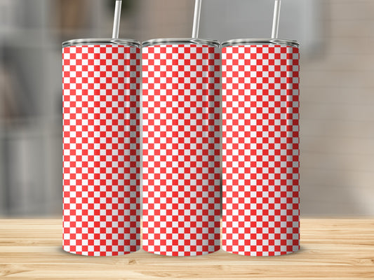 Three tumblers with a red and white checkered pattern sit on a wooden surface.