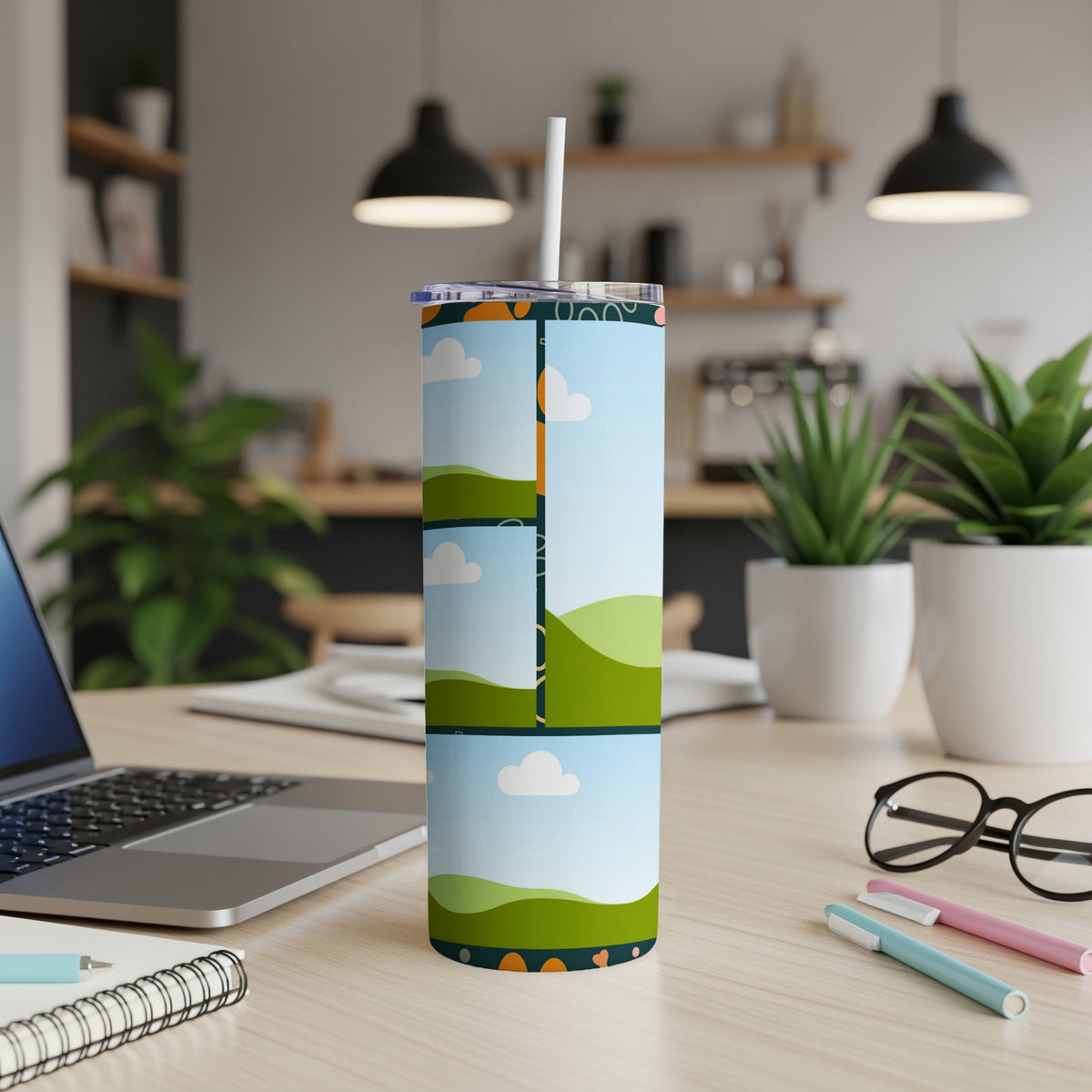 Tall tumbler with a playful cartoon landscape design and straw.