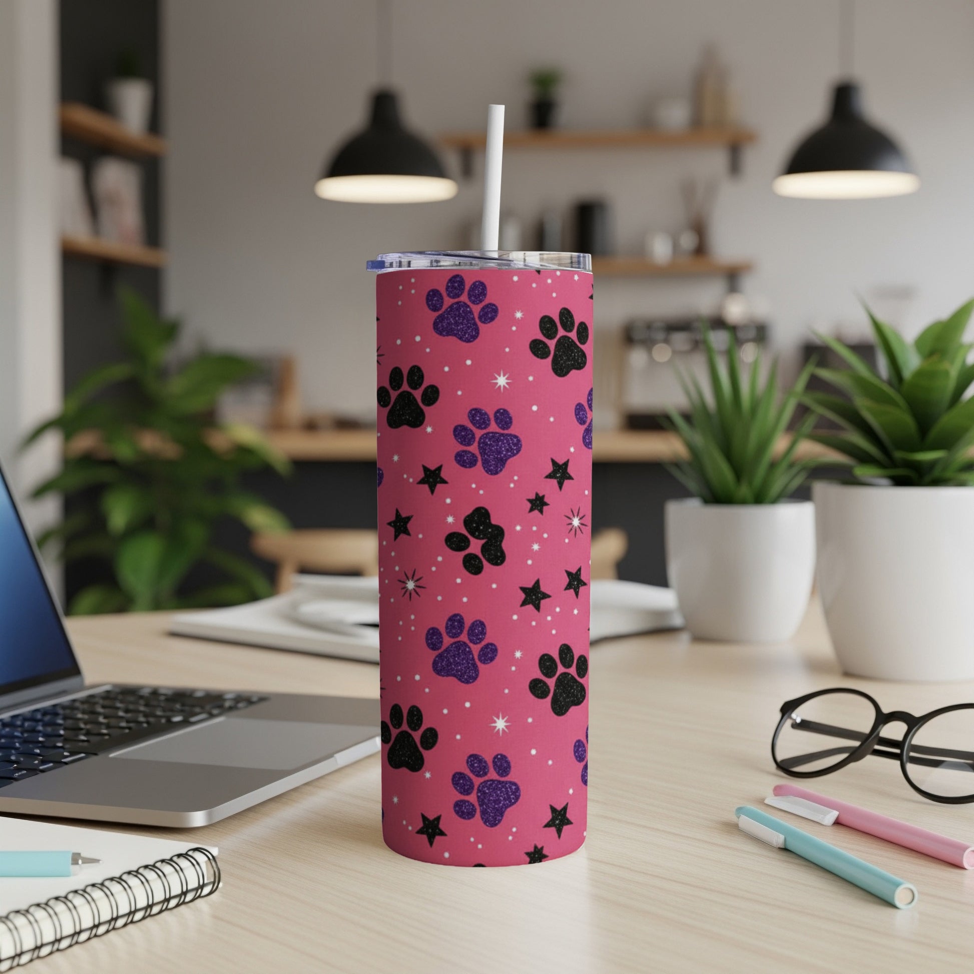 Pink tumbler with black paw prints and glitter stars.