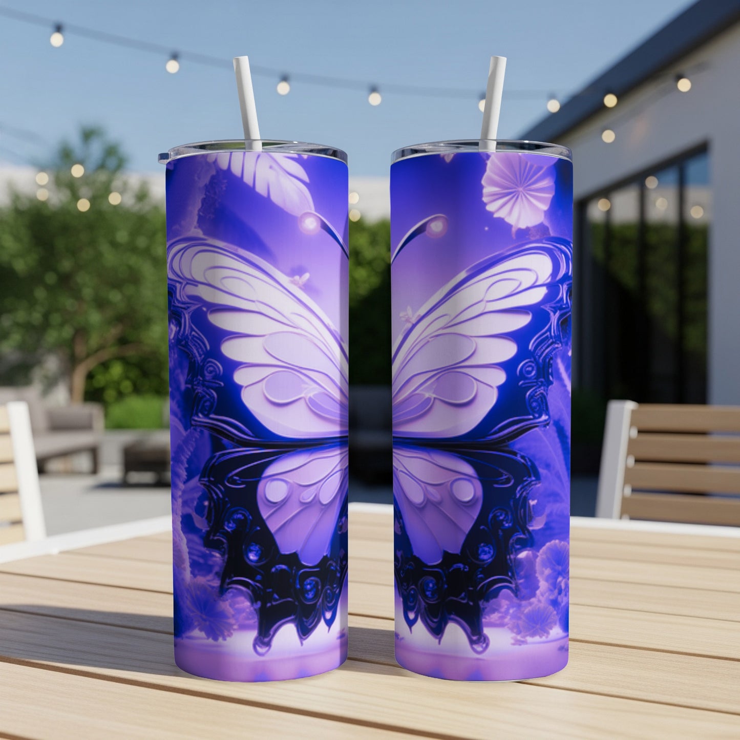 Two purple butterfly patterned tumblers with straws on a wooden table.