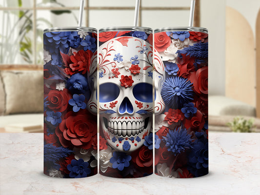 Tumbler with skull design surrounded by red and blue flowers.