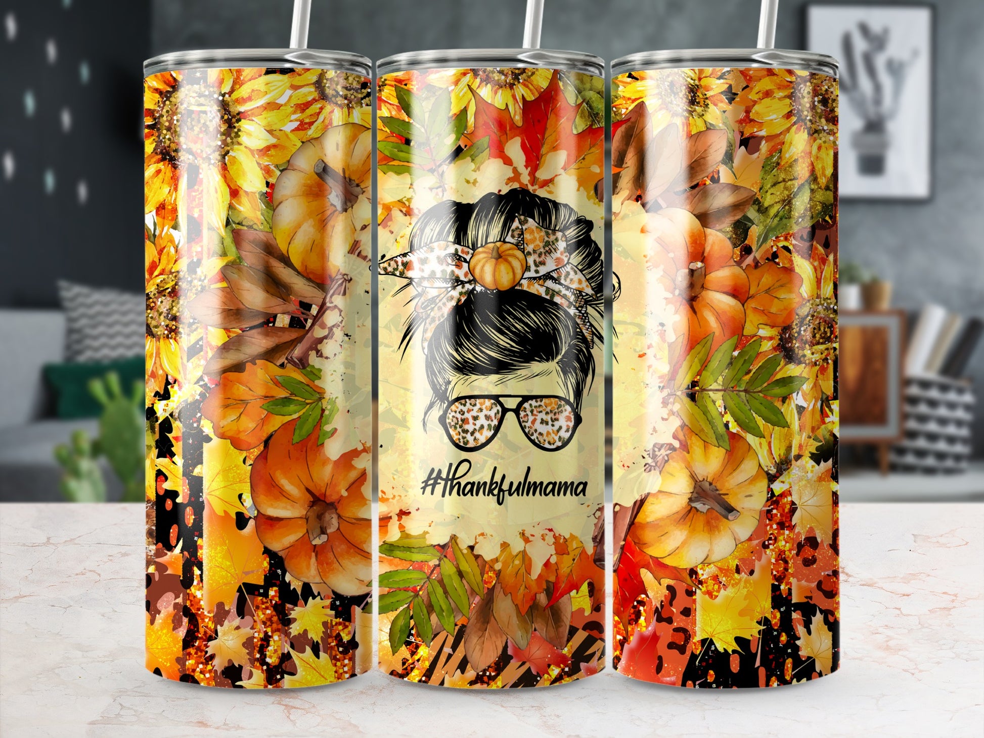 Tumbler with a messy bun, pumpkin, and "#thankfulmama" text, surrounded by autumn leaves.