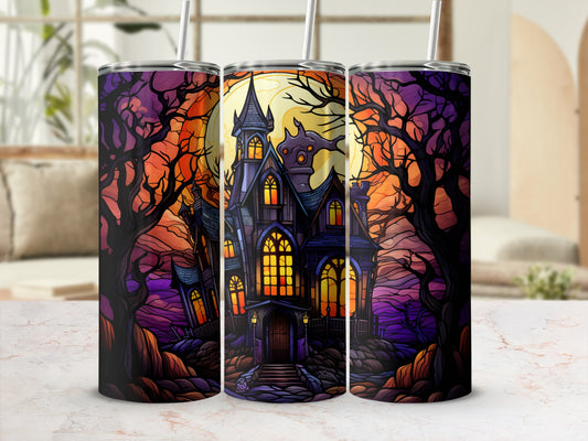 Haunted house with spooky trees and moon, displayed on a marble countertop.