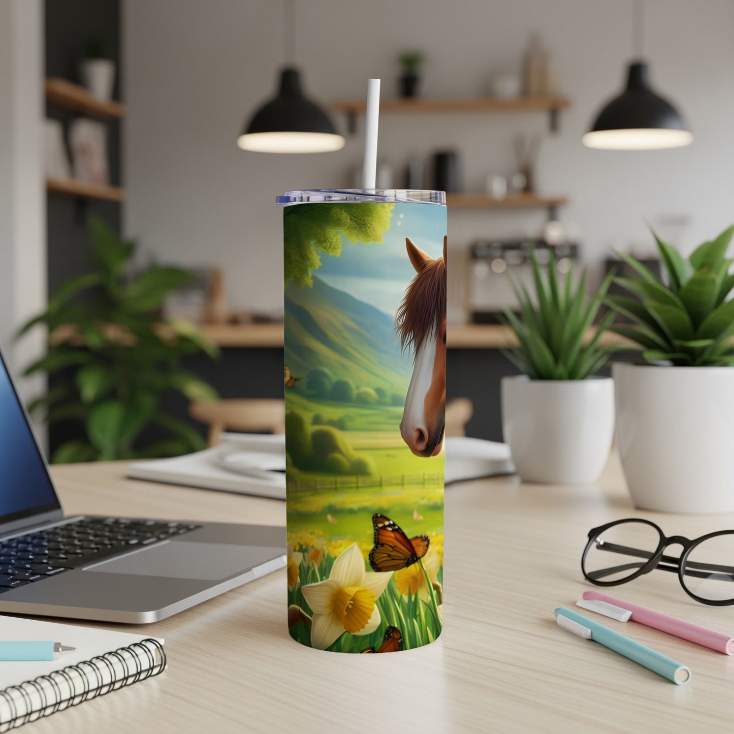 Tall tumbler with horse and butterfly artwork on a desk.