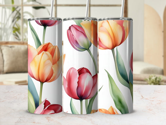 Three tumblers with floral tulip patterns on a marble countertop.