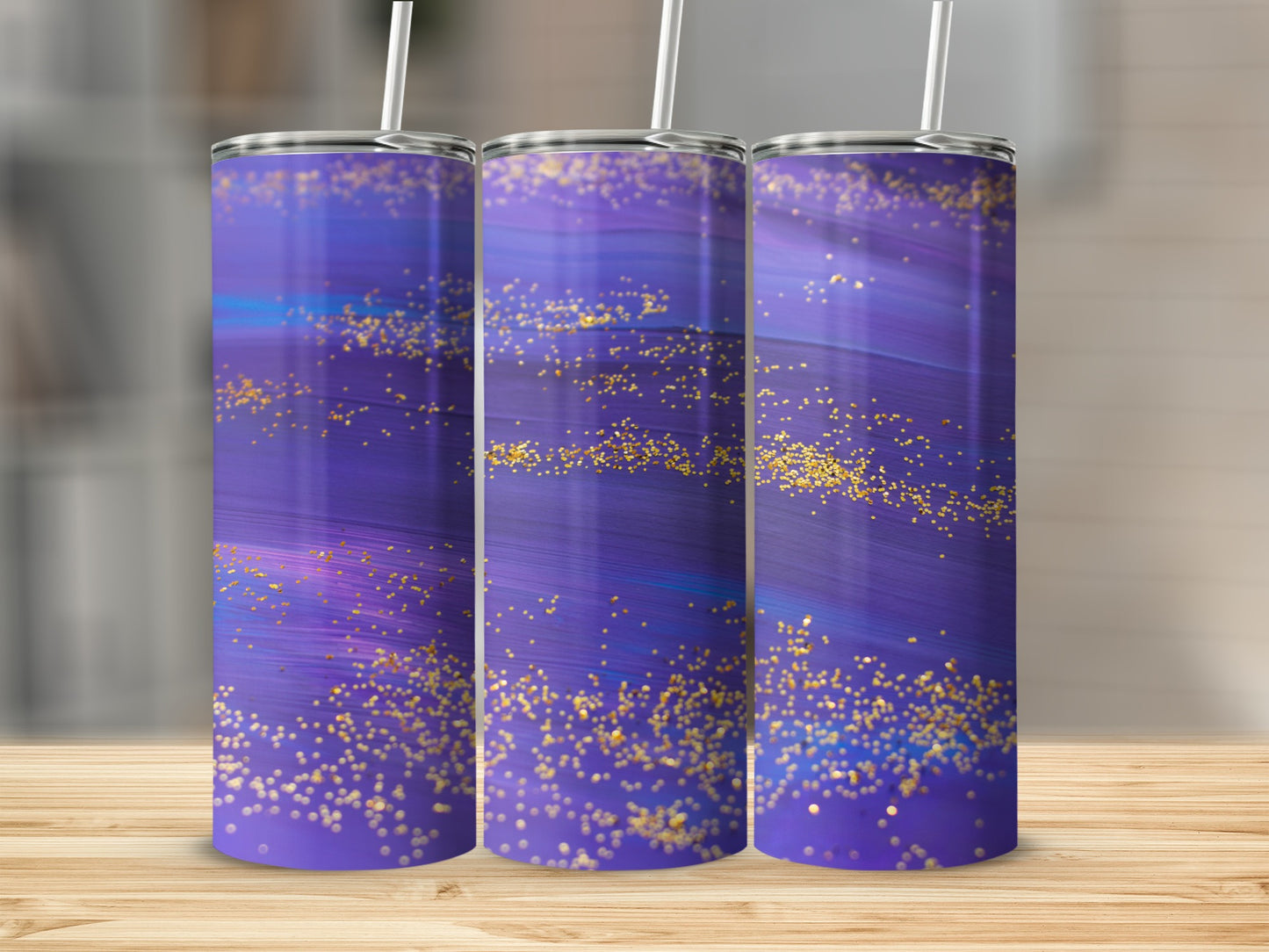Three purple tumblers with gold glitter and blue streaks.