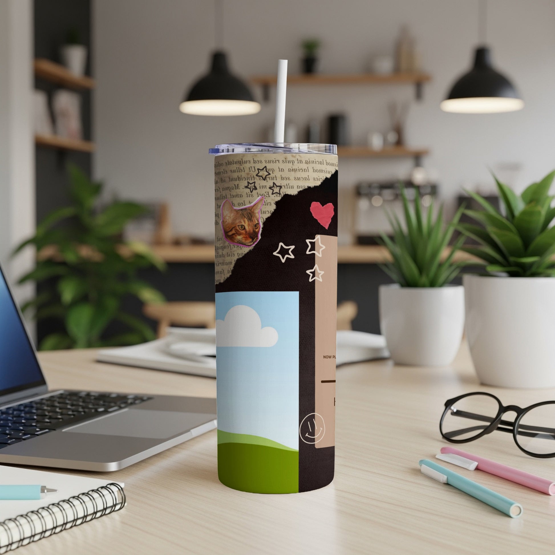 Collage tumbler with cat, stars, heart, and landscape design.
