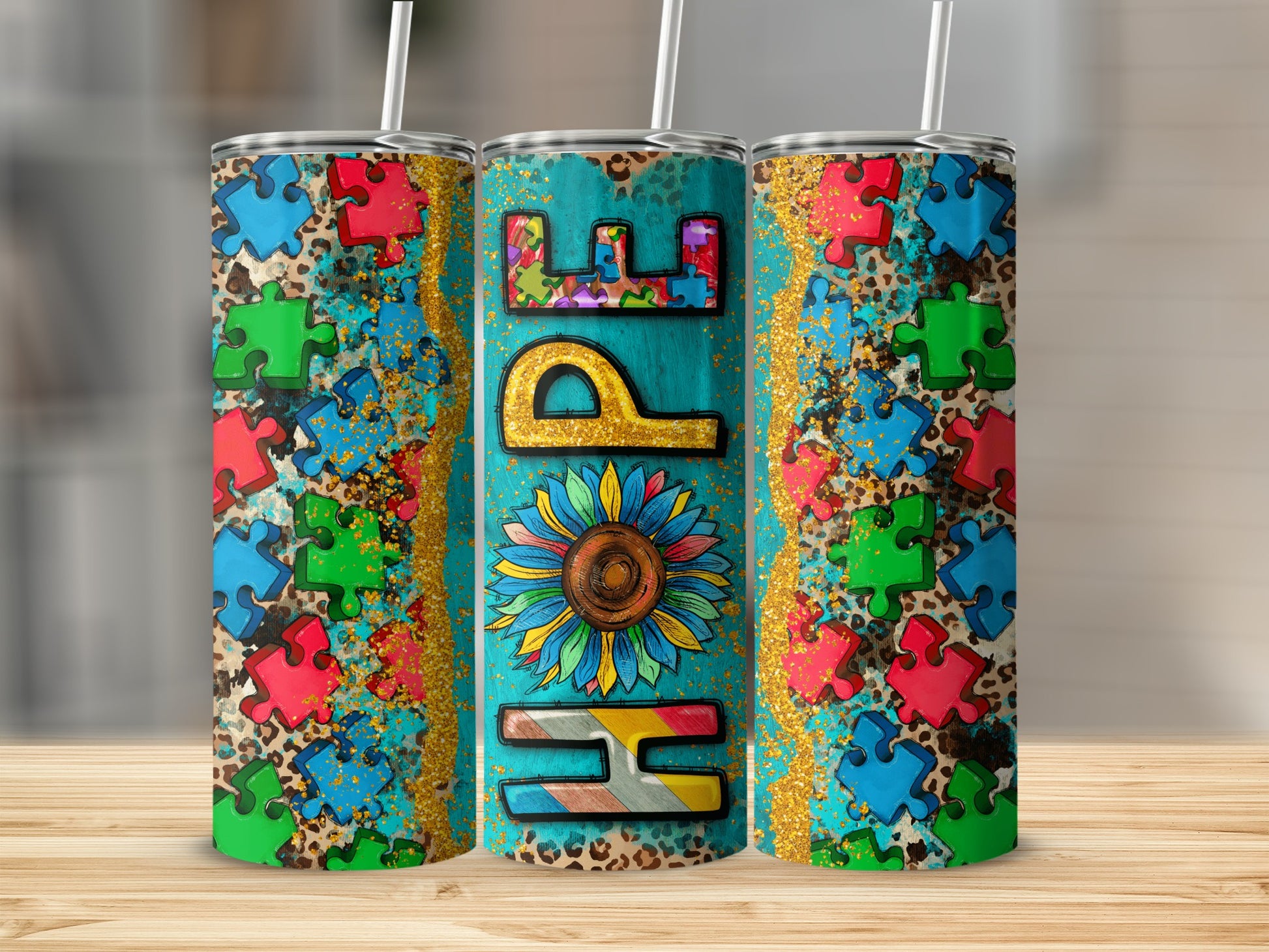 Three tumblers with a bright floral and puzzle piece design with the word "Hope" on the center tumbler.