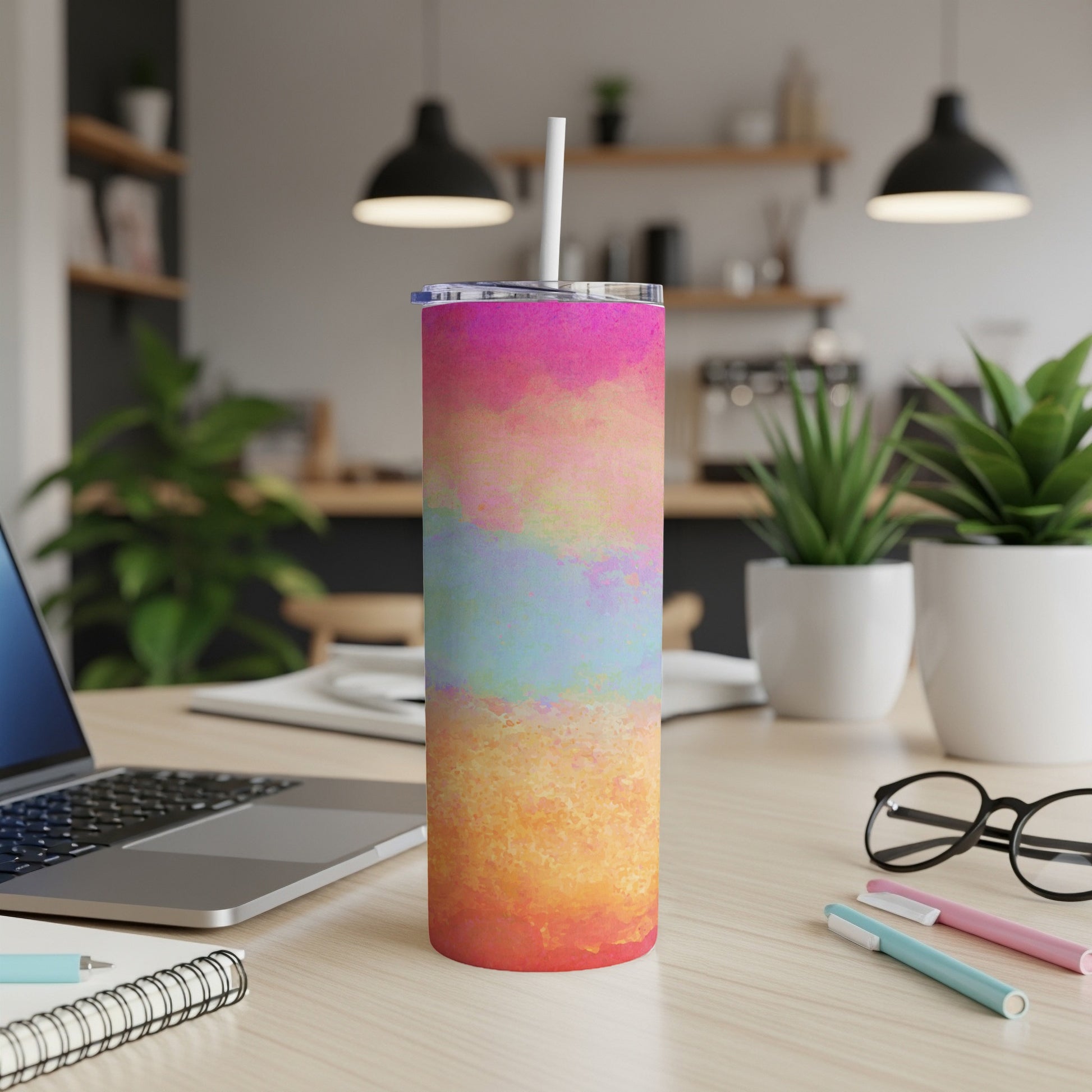 Tall tumbler with watercolor abstract design, white straw, and clear lid.