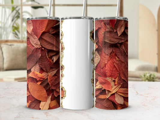 White tumbler with gold glitter edge, surrounded by autumn leaves.