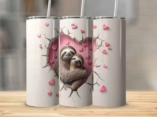 Two sloths embracing through a cracked heart on a white tumbler with pink hearts.