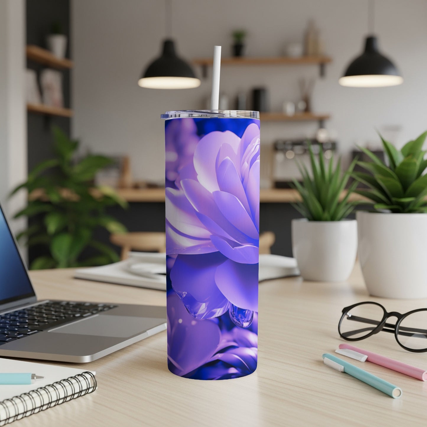 Purple floral tumbler with water droplets and a white straw on a desk.