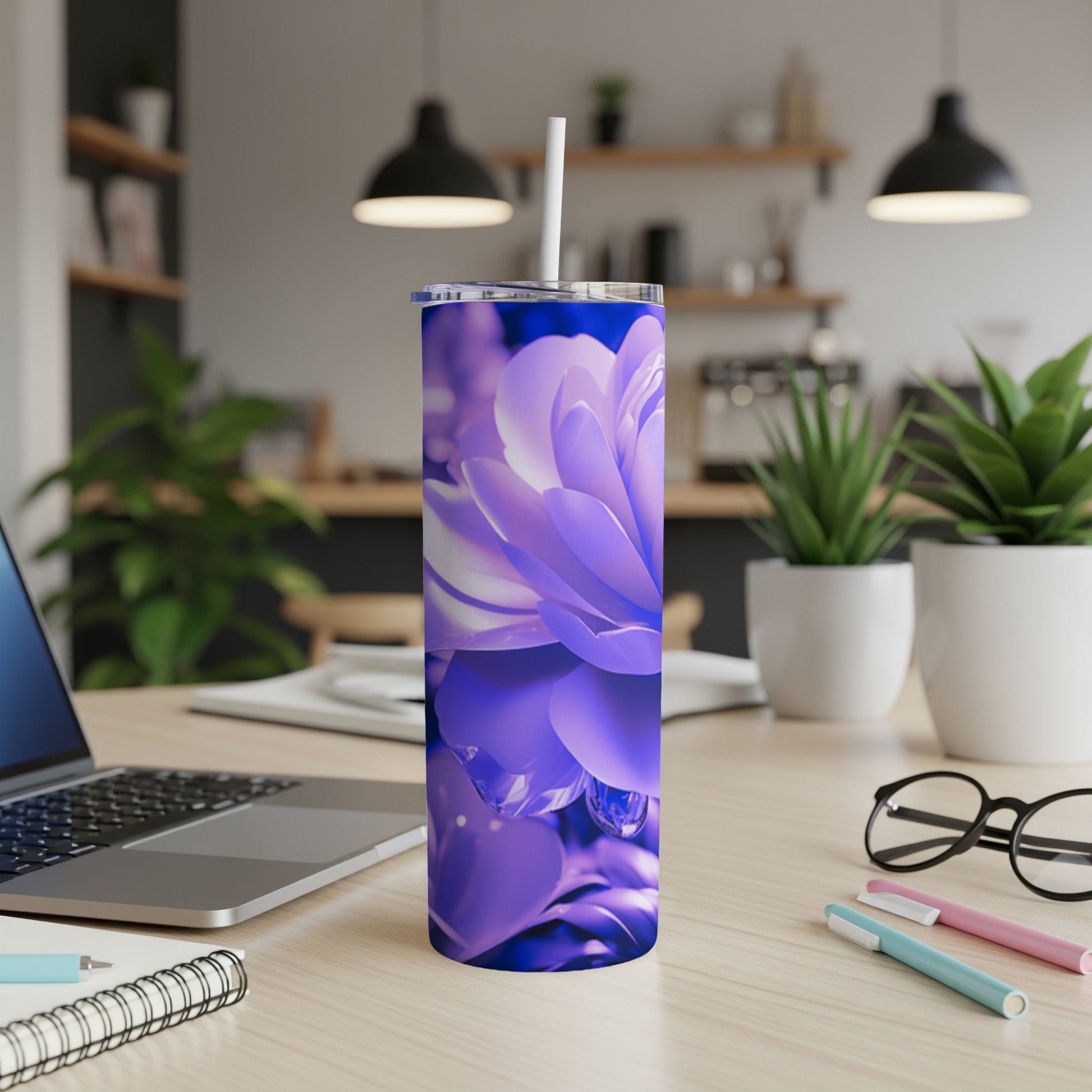 Purple floral tumbler with water droplets and a white straw on a desk.