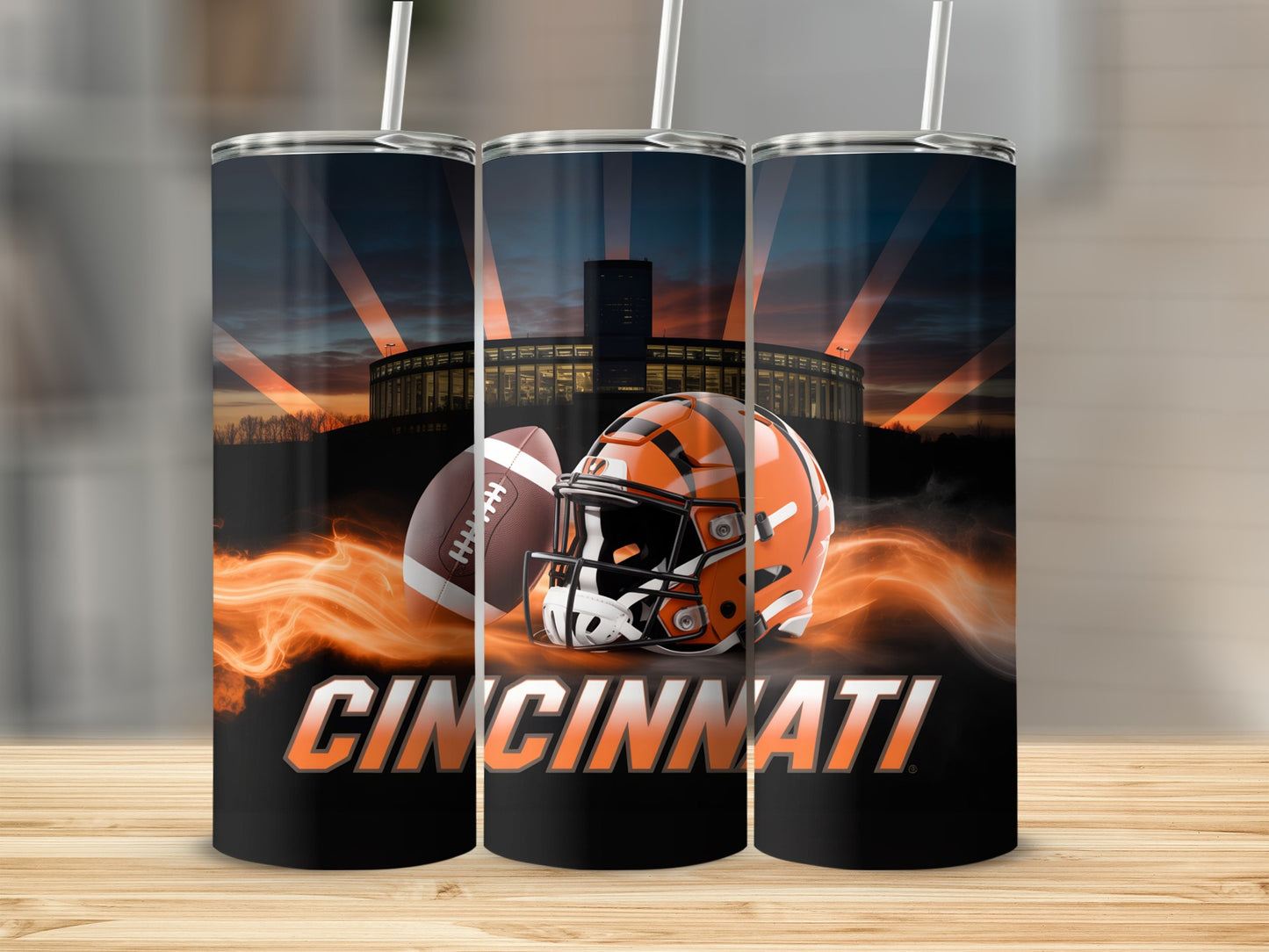 Cincinnati Bengals football helmet and ball with stadium at sunset.