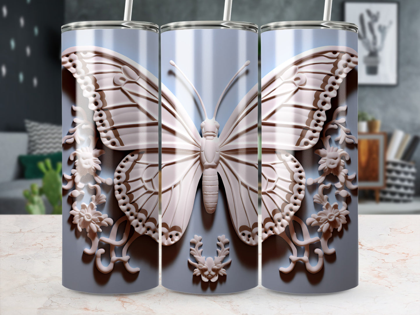 Three tumblers with embossed light pink butterflies and floral accents on a light blue background.