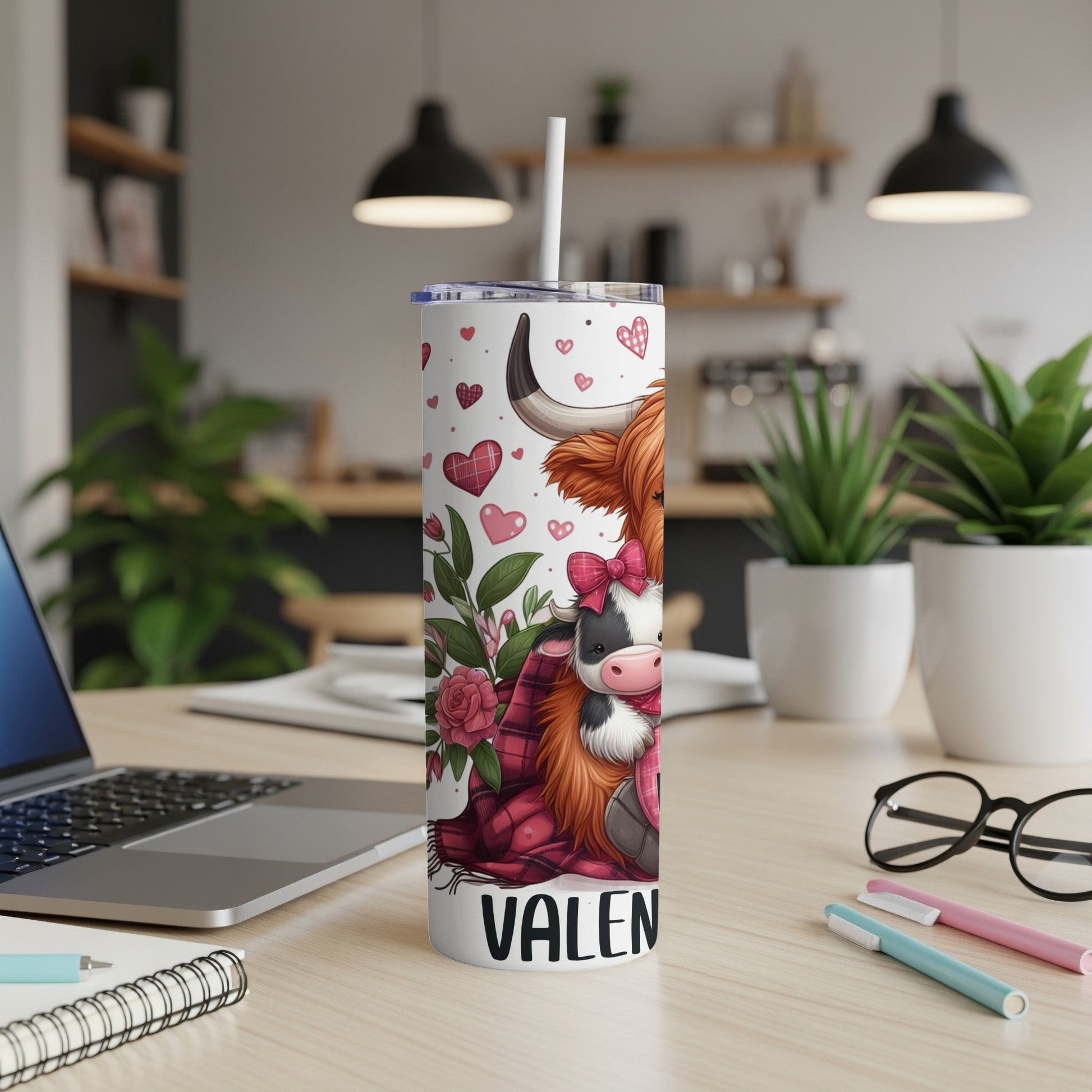White tumbler with a cartoon Highland cow and hearts, labeled "VALEN".