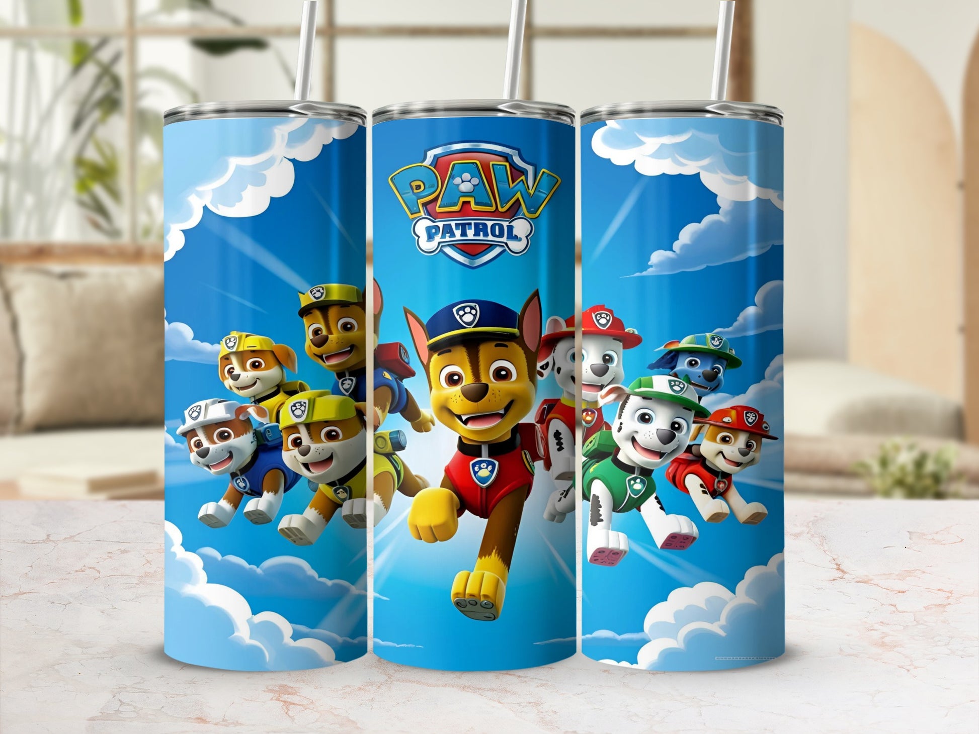 Paw Patrol characters Chase, Marshall, and Ryder on blue tumblers with clouds.