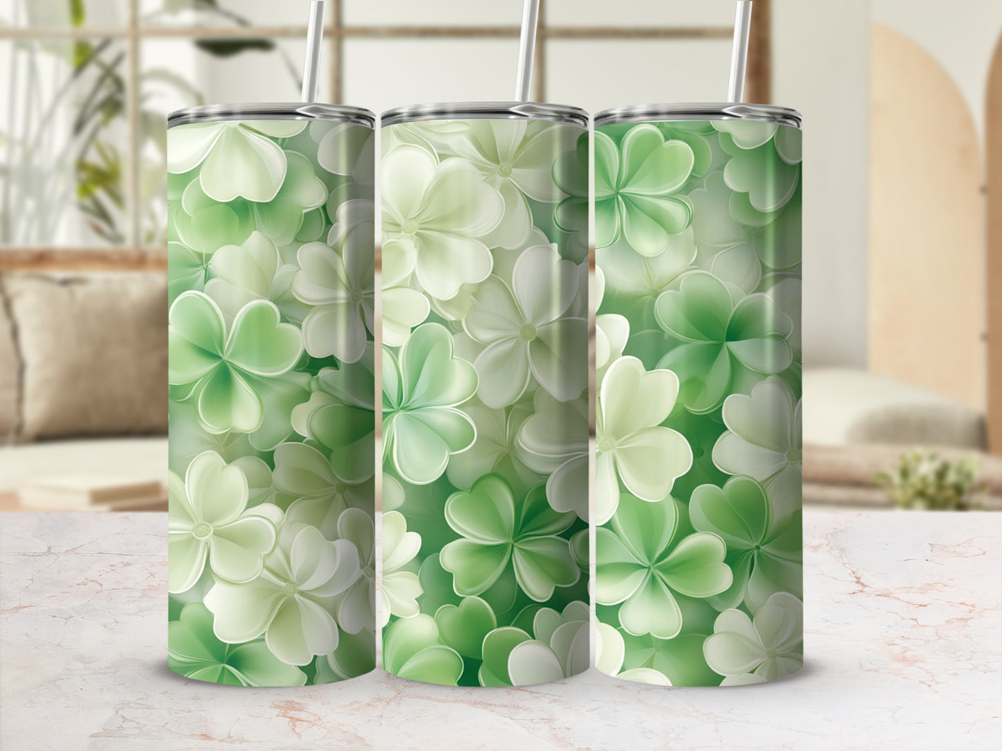 Green clover pattern on three cylindrical tumblers with straws.