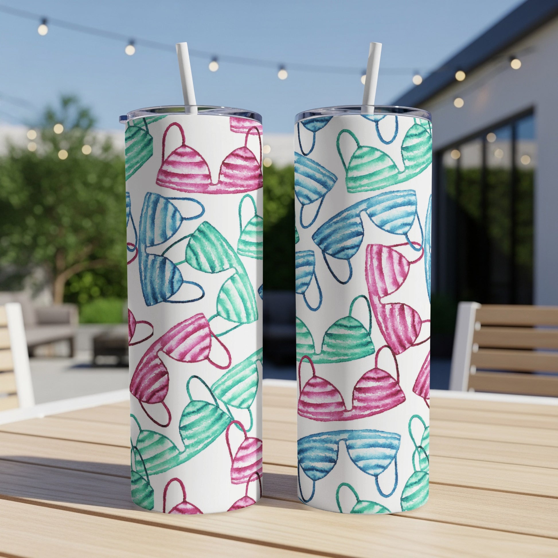 Two tumblers with a watercolor pattern of pink, blue, and green bikini tops.