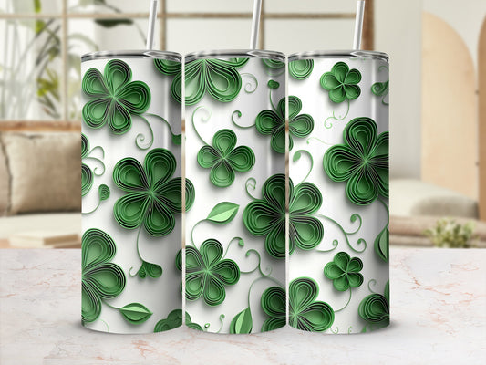 Three green clover patterned tumblers with straws, displayed on a marble surface.
