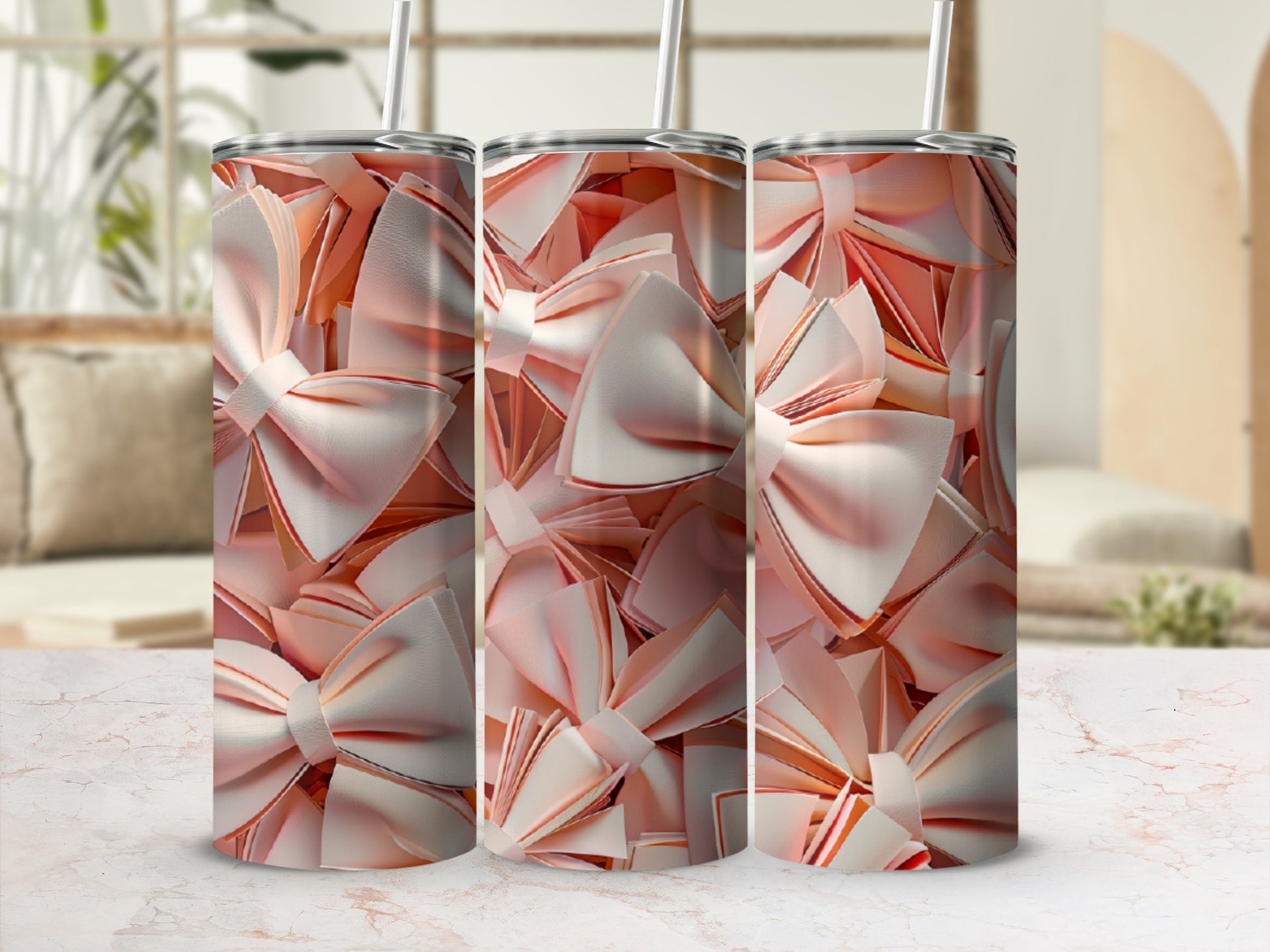 Three tumblers with a pink bow pattern against a blurred background.