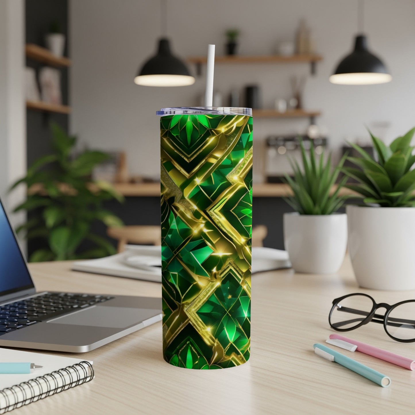 Green and gold abstract geometric pattern tumbler with a straw.