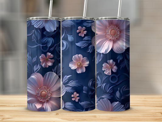Three tumblers with floral patterns on a wooden surface.