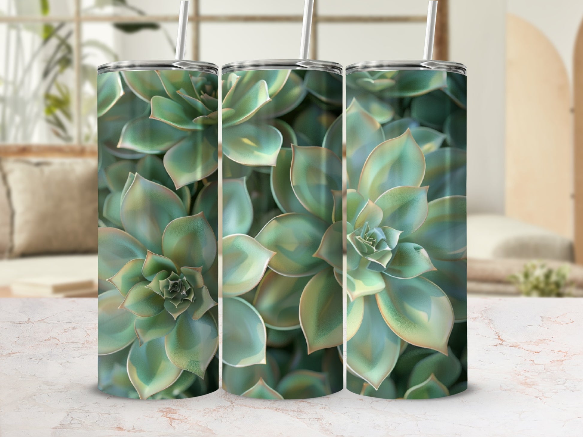 Three tumblers with succulent plant design on a marble surface.
