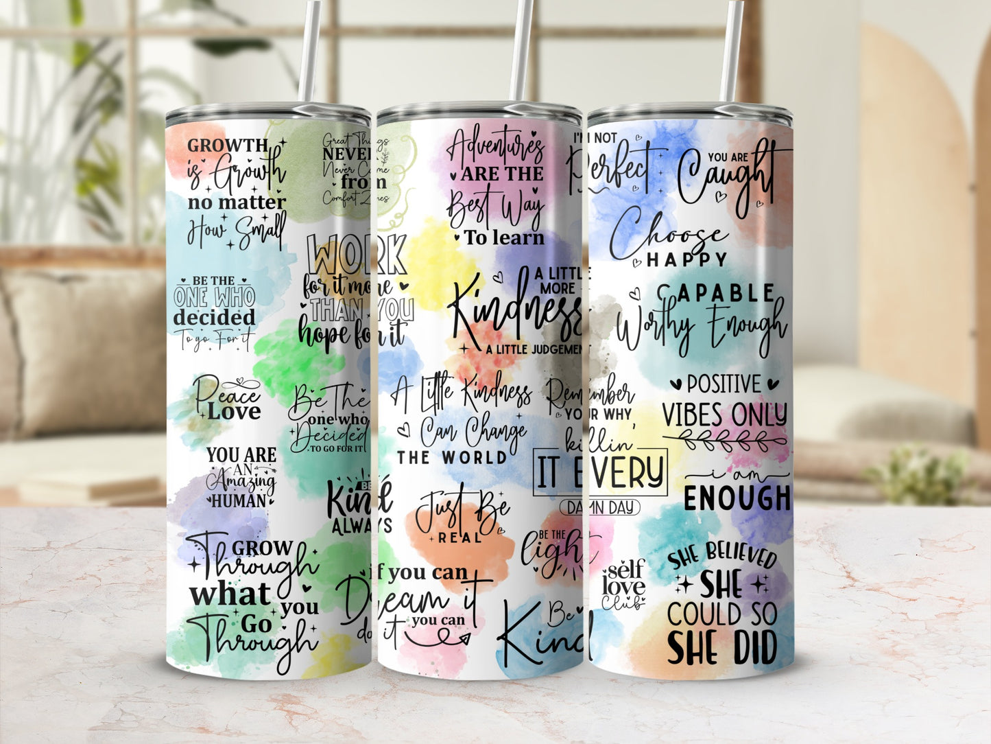 Three colorful tumblers with inspirational quotes and designs.