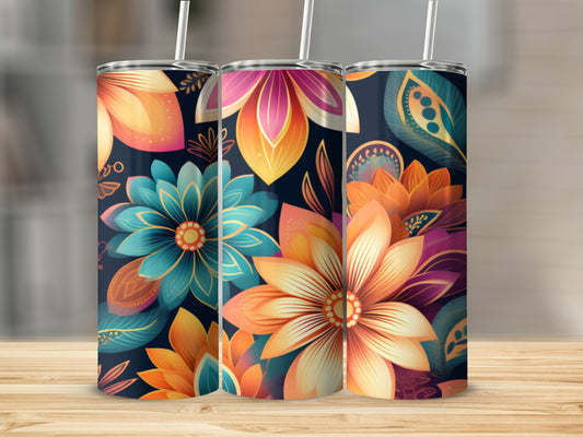 Three tumblers with colorful floral designs on a wooden surface.