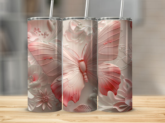 Pink butterfly and floral embossed tumblers on a wooden surface.