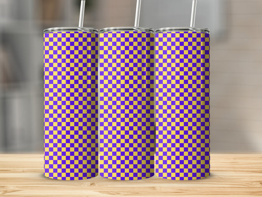 Three purple and yellow checkered tumblers with straws displayed on a wooden surface.