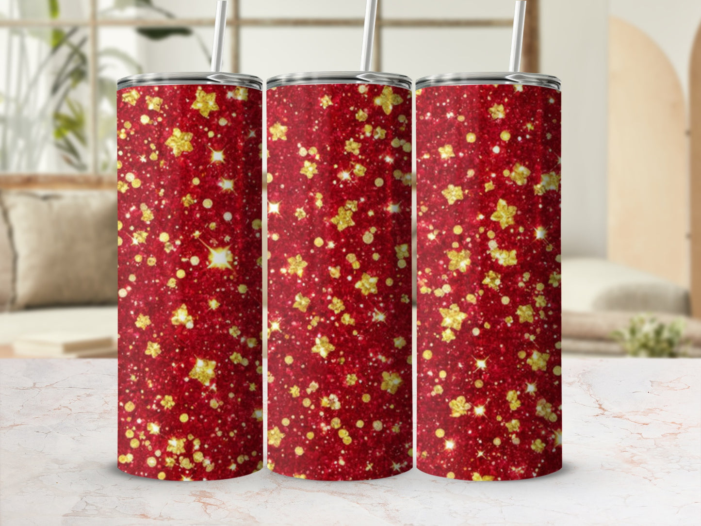 Three red glitter tumblers with gold star accents and straws.