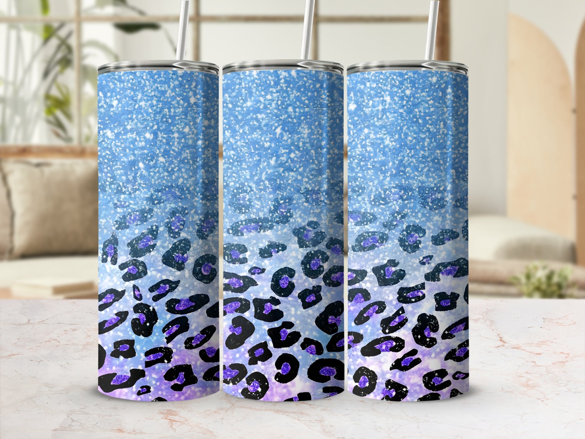 Three glittery blue tumblers with purple leopard print pattern.