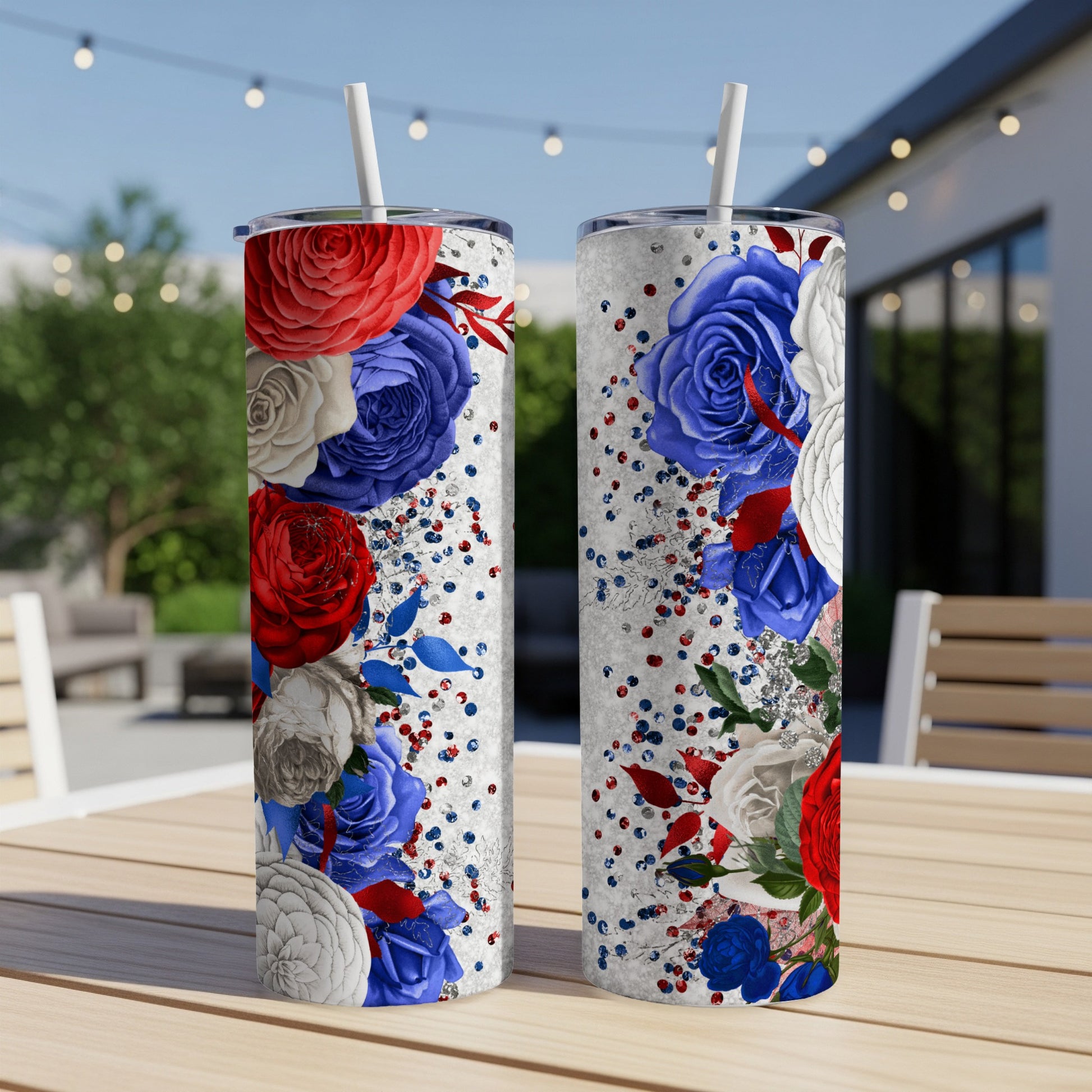 Two patriotic tumblers with red, white, and blue floral designs and glitter.
