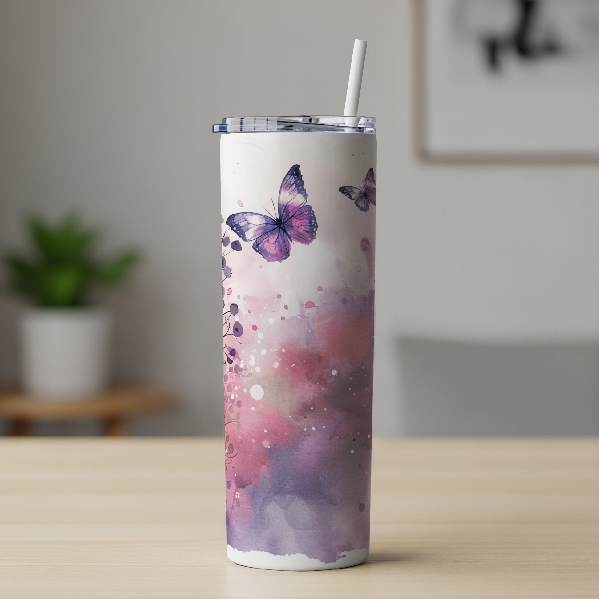 White tumbler with purple watercolor butterflies and floral accents, straw inserted.