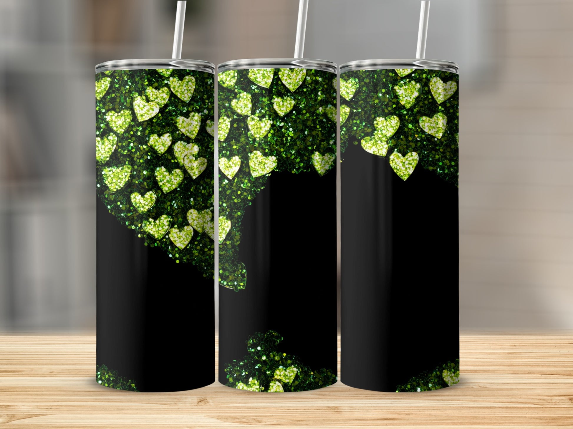 Black tumbler with shimmering green glitter hearts and a subtle wood background.
